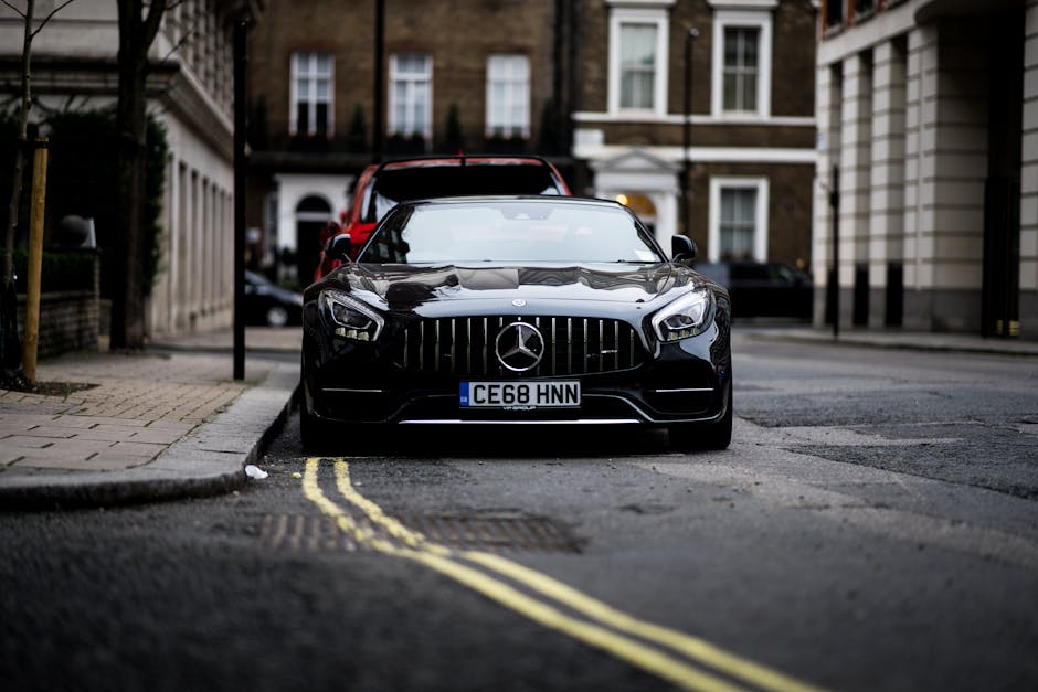 A sleek black Mercedes Benz parked on a London street, showcasing luxury and style