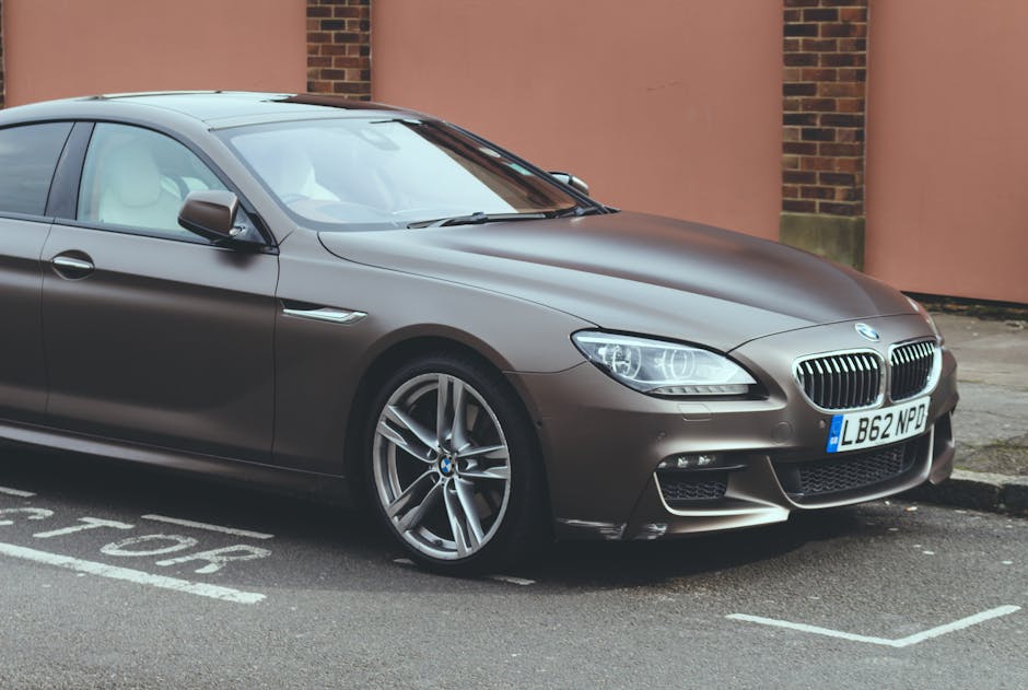 Luxury BMW 6 Series coupe parked on an urban street, showcasing sleek design and elegance