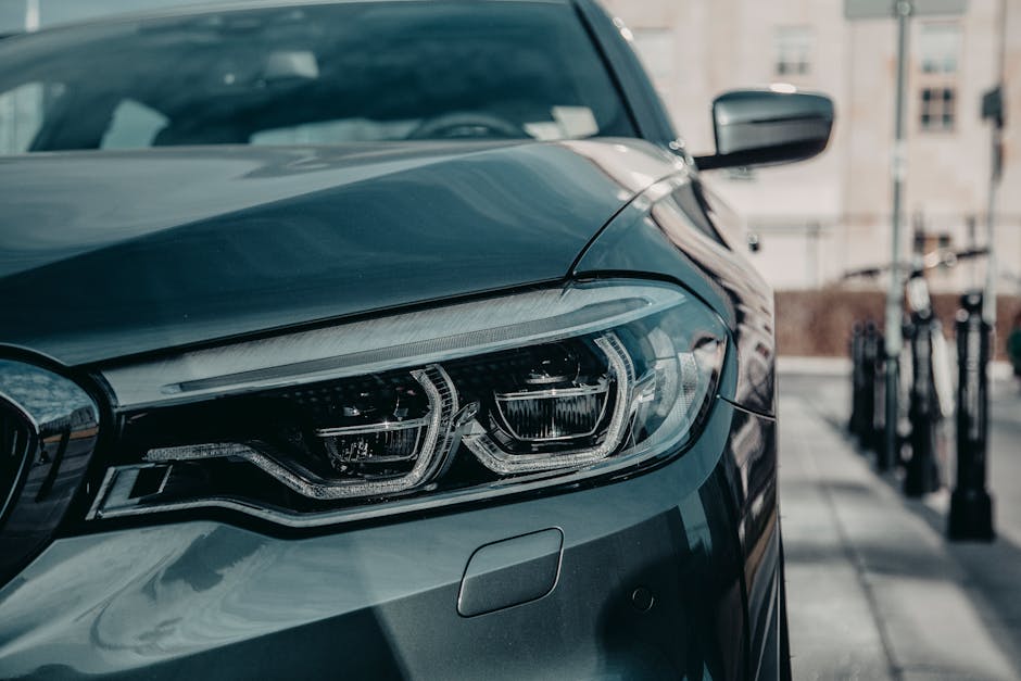 New shiny automobile on asphalt road near building in town street in daylight